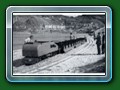 1952: Dingo (original design) & train of the first set of articulated open carriages sit at the Ferry, note platforms not yet built and no Canteen siding, from book 'Short History of Fairbourne Railway' - Bill Hyde collection