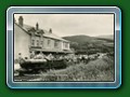 circa 1950: 'Count Louis' with train of Bassett-Lowke 4-wheel carriages waits to depart from the original Fairbourne terminus - postcard, Bill Hyde collection